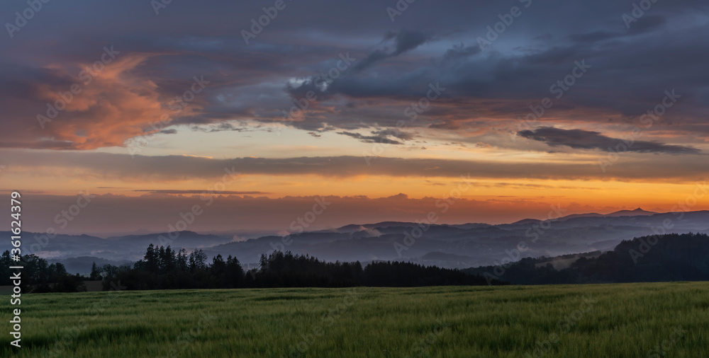 Obraz premium Sunset in hot summer rainy evening near Roprachtice village