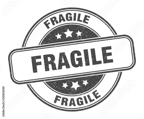 fragile stamp. fragile round grunge sign. label