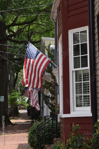 An American flag hanging from a house