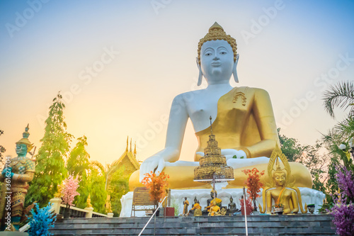 Beautiful big buddha image at Wat Phra That Doi Kham. Chiang Mai, Thailand. Wat Phra That Doi Kham (Wat Doi Kham or the Golden temple) is located at the top of a hill to the south west of the city. photo