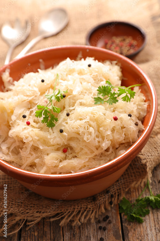 cabbage- choucroute, sauerkraut on wood background cabbage- choucroute, sauerkraut on wood background