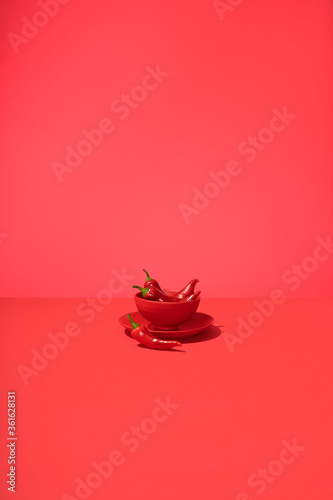 Hot Spicy Fresno Peppers in Bowl on Table Top Red Surface and Background.  Monochromatic  Set photo