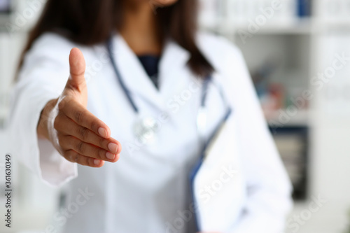 Doctor shake hand as hello with patient in office closeup. Welcoming friend introduction or thanks gesture consultation work thankful client talk team trust communication teamwork deal concept