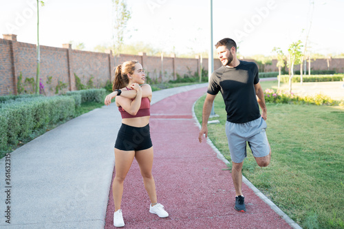 Couple Exercising Together In Park