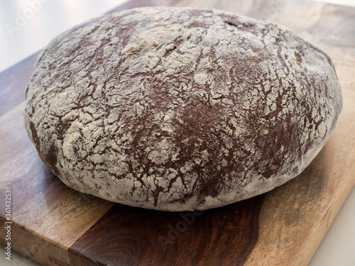 Pumpernickel Bread, Whole Loaf on Bread Board , Horizontal