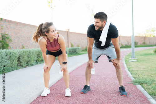 Young Sporty Couple Resting In Park