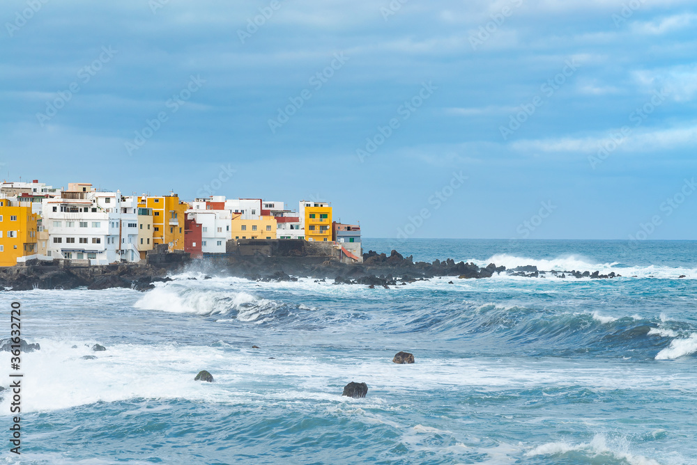 View on ocean shore and colorful buildings on the rock in Punta Brava, Puerto de la Cruz, Tenerife, Canary Islands, Spain