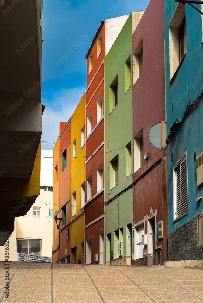 Colorful buildings on a narrow street in spanish town Punto Brava on a sunny day, Tenerife, Canary islands, Spain.