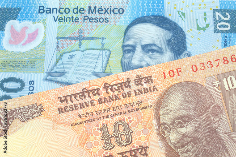 An orange, Indian ten rupee bill, close up with A blue twenty peso note from Mexico