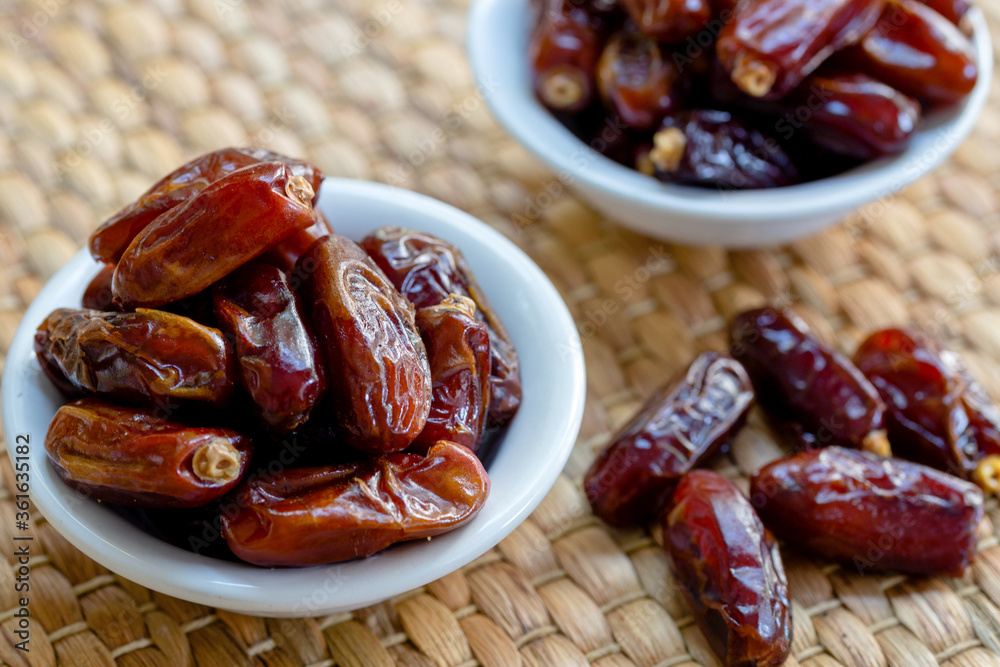 Fresh red dates (hurma) in bowl Fresh red dates (hurma) in bowl