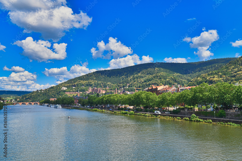 Heidelberg neckar river with old historical buildings and Odenwald mountain range with famous castle in Germany during summer