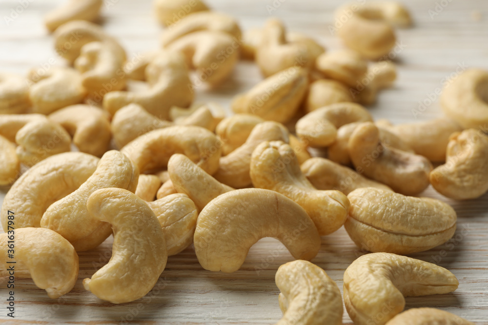 Tasty cashew nuts on white wooden background. Vitamin food Tasty cashew nuts on white wooden background. Vitamin food