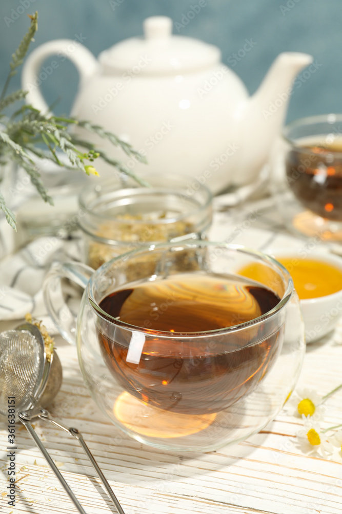 Composition with chamomile tea on white wooden table Composition with chamomile tea on white wooden table