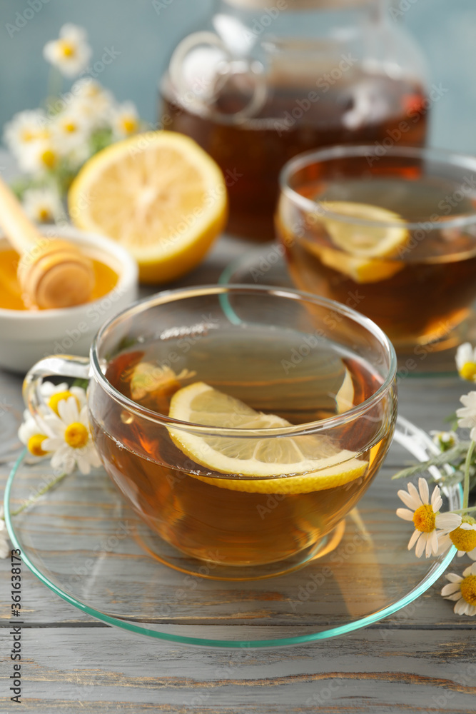 Composition with chamomile tea on gray wooden background Composition with chamomile tea on gray wooden background