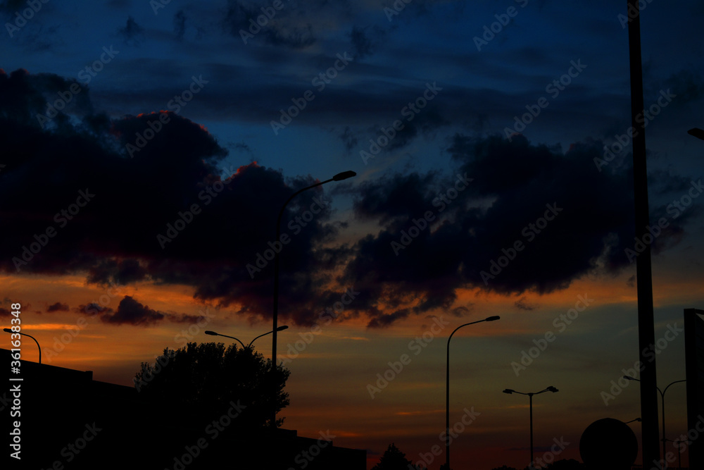 colorful sunset with red sky and trees and clouds colorful sunset with red sky and trees and clouds