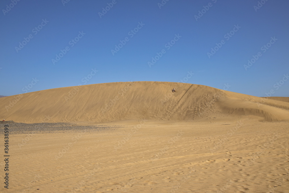 summer desert landscape on a warm sunny day from Maspalomas dunes on the Spanish island of Gran Canaria