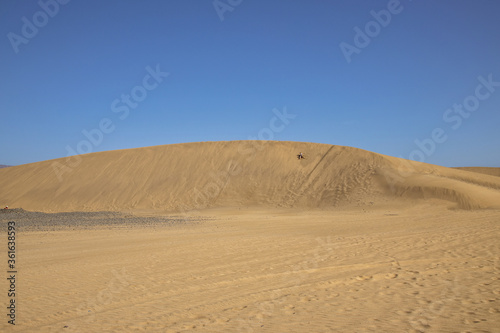 summer desert landscape on a warm sunny day from Maspalomas dunes on the Spanish island of Gran Canaria