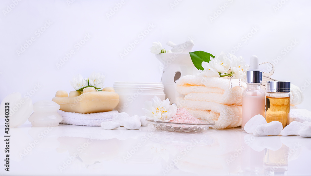 Various spa and beauty threatment products isolated on white background. Skin cream, tonicum bottle, dry flowers, leaves, rose and Himalayan salt. Organic cosmetics, spa concept. Empty. Copy space
