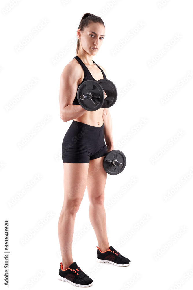 Young athletic woman working out with dumbbells Young athletic woman working out with dumbbells