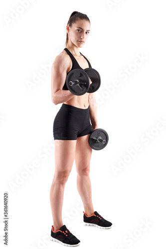 Young athletic woman working out with dumbbells