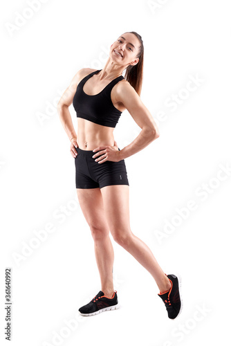 Young female fitness model on white