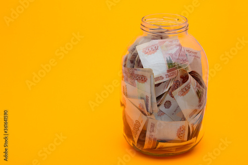 In a glass three-liter jar are five thousandth Russian bills