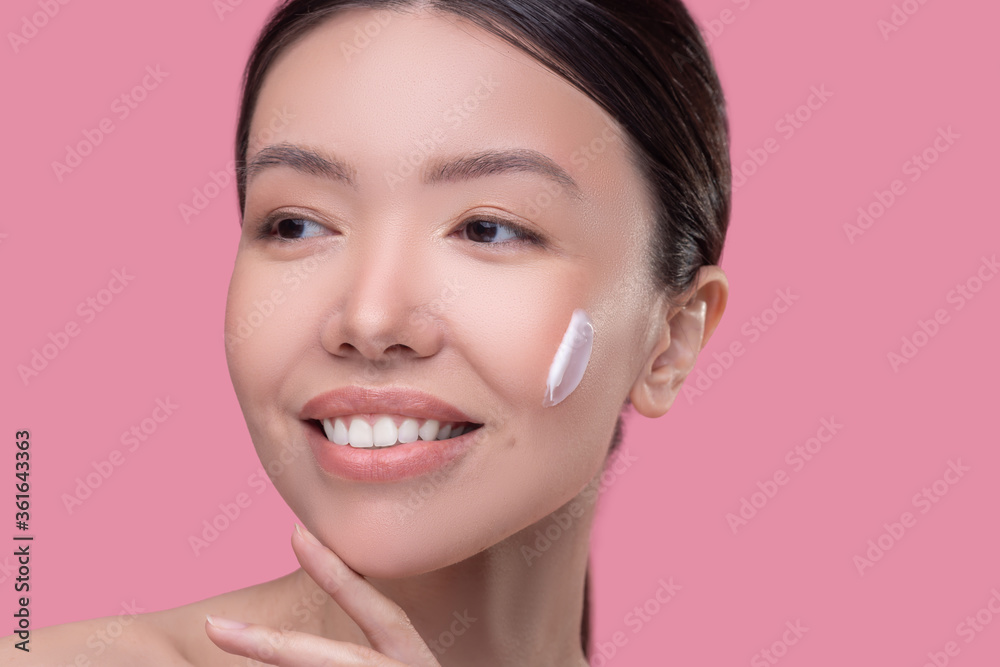 Young beautiful woman doing usual skincare procedure