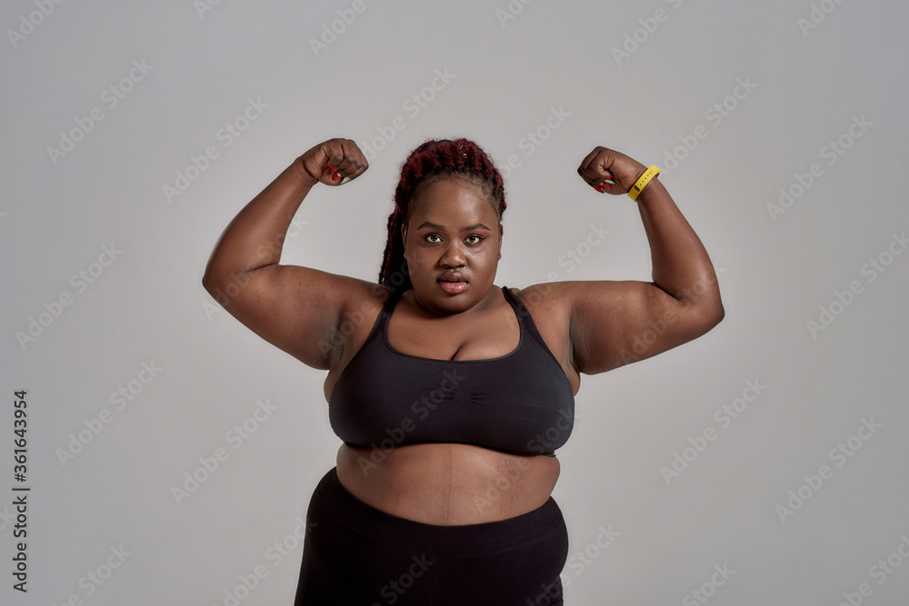Plump, plus size african american woman in black sportswear