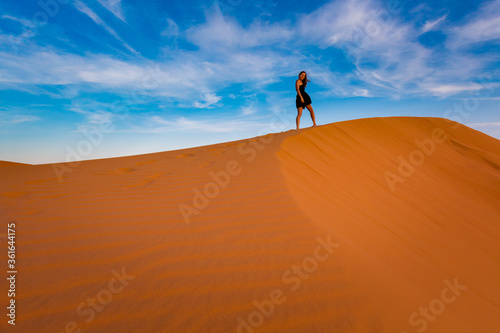 Happy woman on Red sand dunes in Vietnam