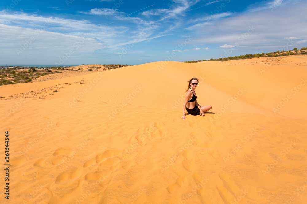 Happy woman on Red sand dunes in Vietnam