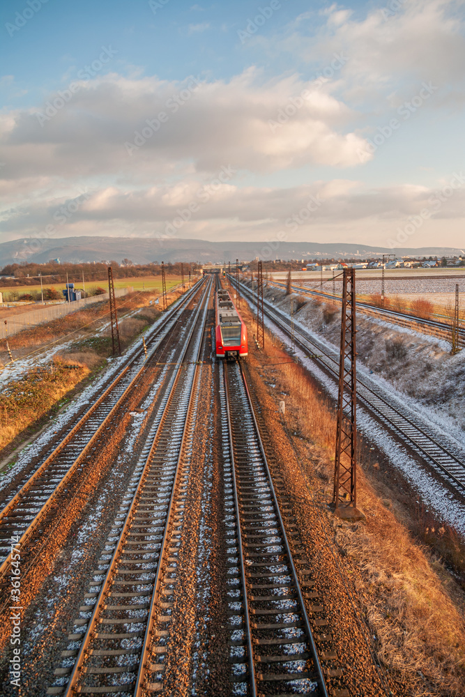 Train is coming to the station during early Spring during sunset in Heidelberg, Germany