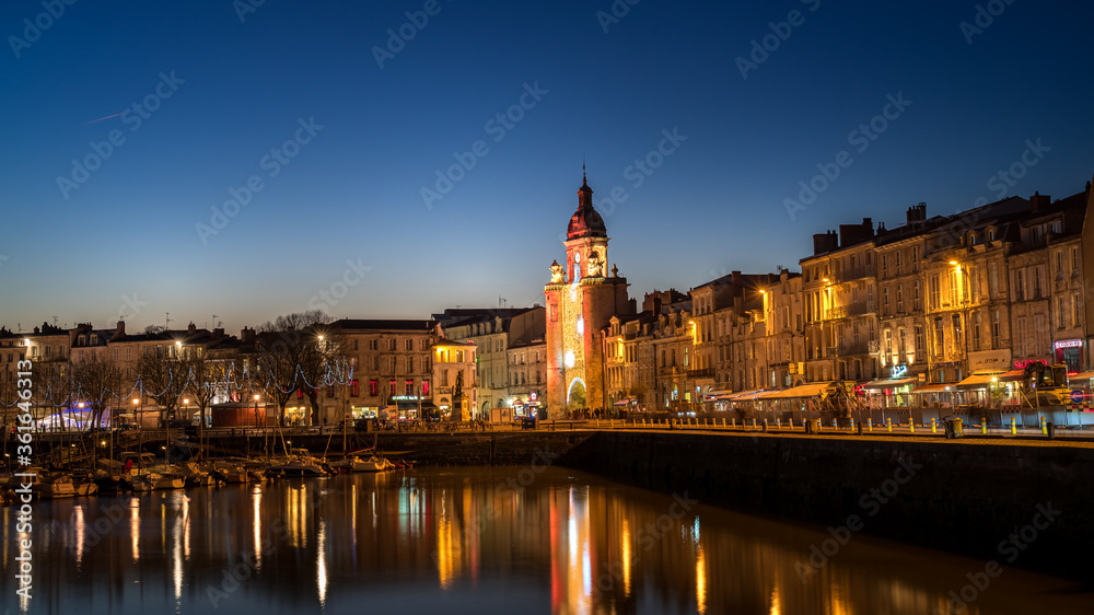 Panoramic view of the grosse horloge of La Rochelle at blue hour with beautiful illuminated city lights