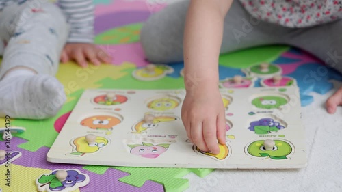 education, home schooling, childhood, science, educational games,self-education concepts.Kids play with afavit and frruit puzzleson blackboard.Brother and sister study in nursery on mat indoors photo