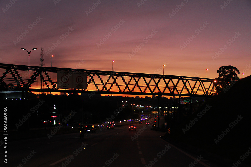 Fototapeta premium Pedestrian walkway in the backlight and sunset in the background