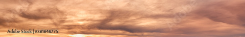 Summer sunset dranatic sky panorama with fleese clouds. Summer evening sky and weather concept background. photo