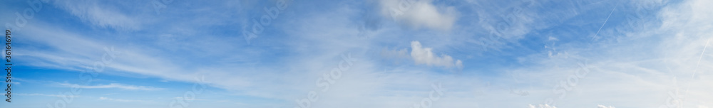 White fluffy cirrus and cirrocumulus clouds  in blue azure sky. Summer sky and good weather concept high resolution background.