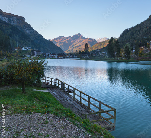 Autumn morning alpine Dolomites mountain lake Alleghe, Belluno, Sudtirol, Italy. Picturesque view from Alleghe village park Rusech.