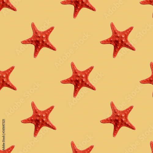 Red seastar seamless pattern isolated on yellow background