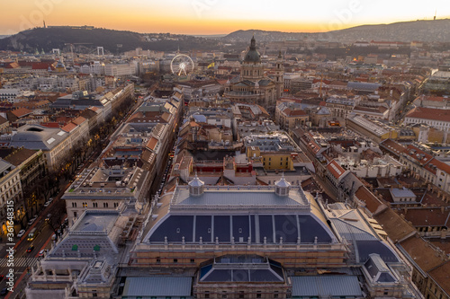 Aerial drone shot of St. Stephen's Basilica over opera house in Budapest sunrise morning glow