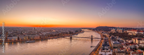 Panoramic aerial drone shot of Budapest by danube river with lights on before sunrise hour