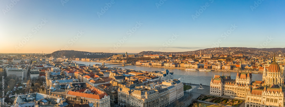 Panoramic aerial drone shot of Danube river with Buda castle and Hungarian Parliament in Budapest