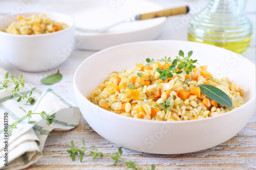 Pearl barley warm salad with carrots and fried onions, thyme garnish