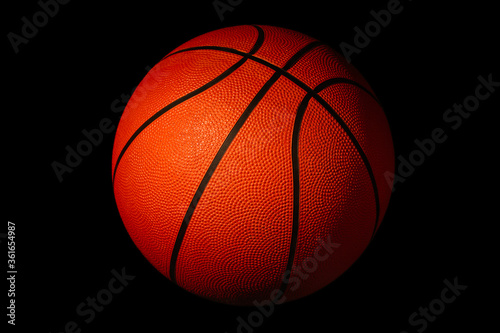 Basketball isolated on a black background as a sports and fitness symbol © Алексей Сыркин
