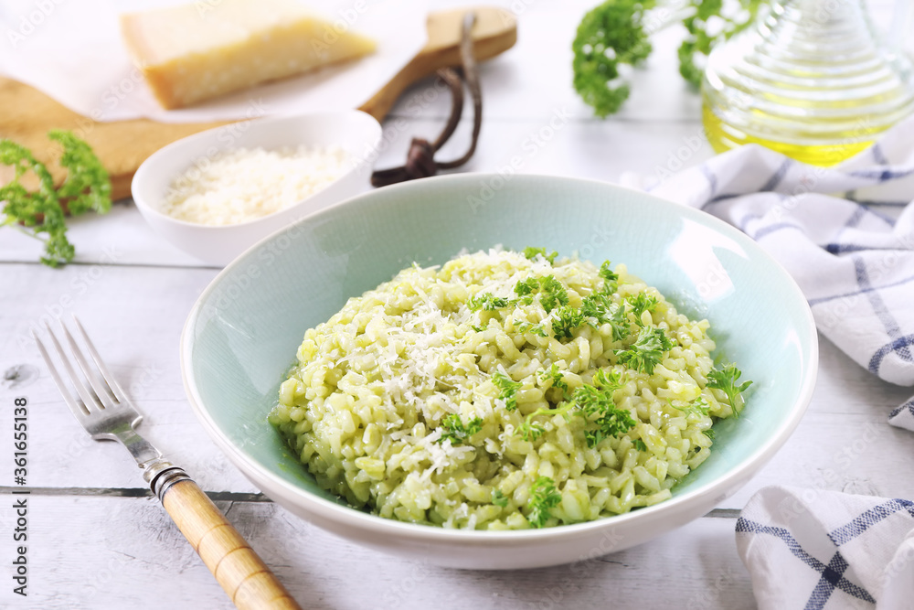 Italian cuisine. Plate of parsley risotto, olive oil and Parmesan cheese