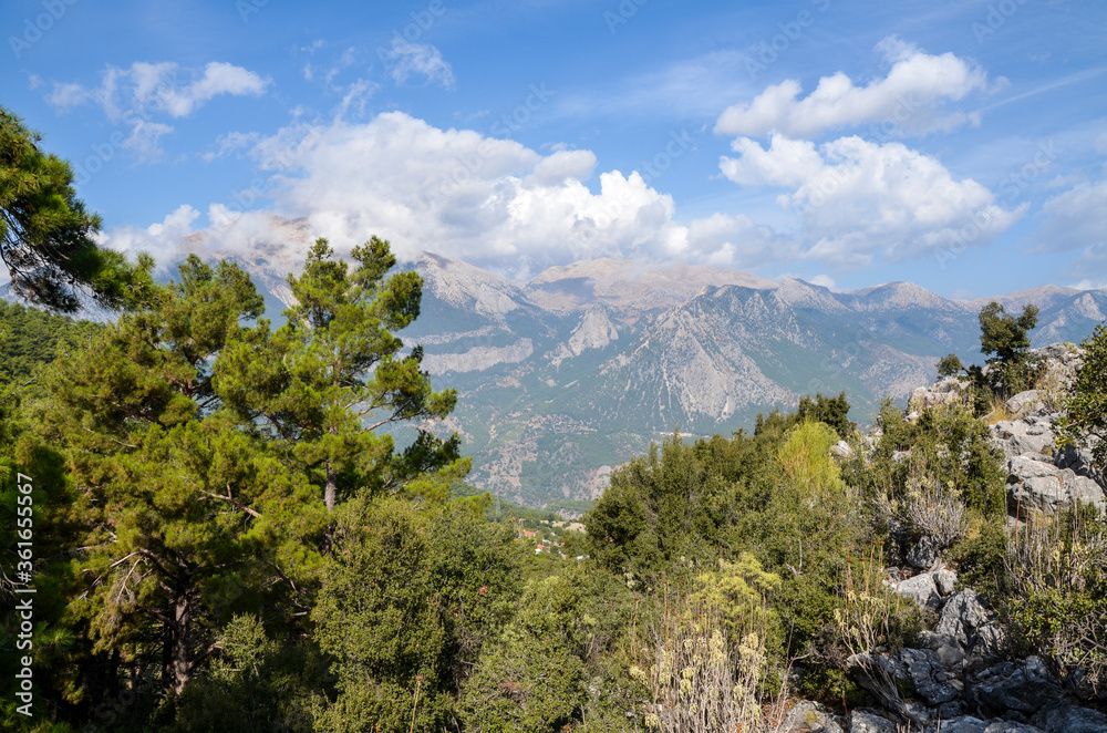 View to mountain ridge in Taurus Mountains, stony hills with rock on green mountain meadow from famous Lycian Way tourist path in Turkey