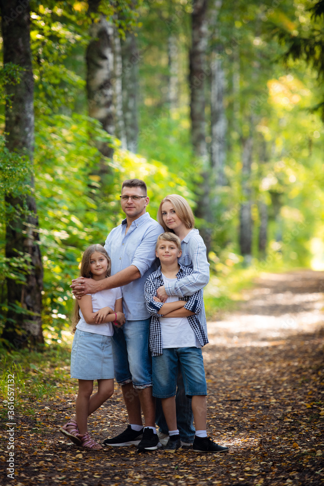 Happy family outdoors smiling in a summer forest