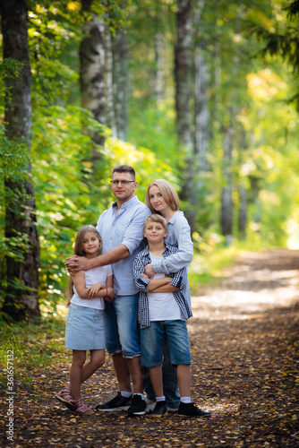 Happy family outdoors smiling in a summer forest