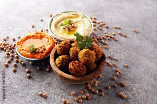 Traditional homemade hummus, falafel and chickpea on rustic table. Jewish Cuisine.