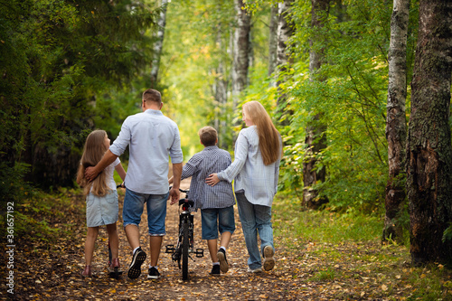 Happy family outdoors smiling in a summer forest