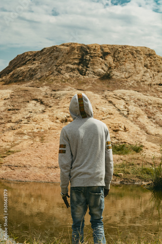 a close up a Young black man at hill from a distance